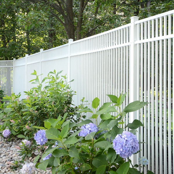 Travertine white aluminum fencing with greenery and purple flowers