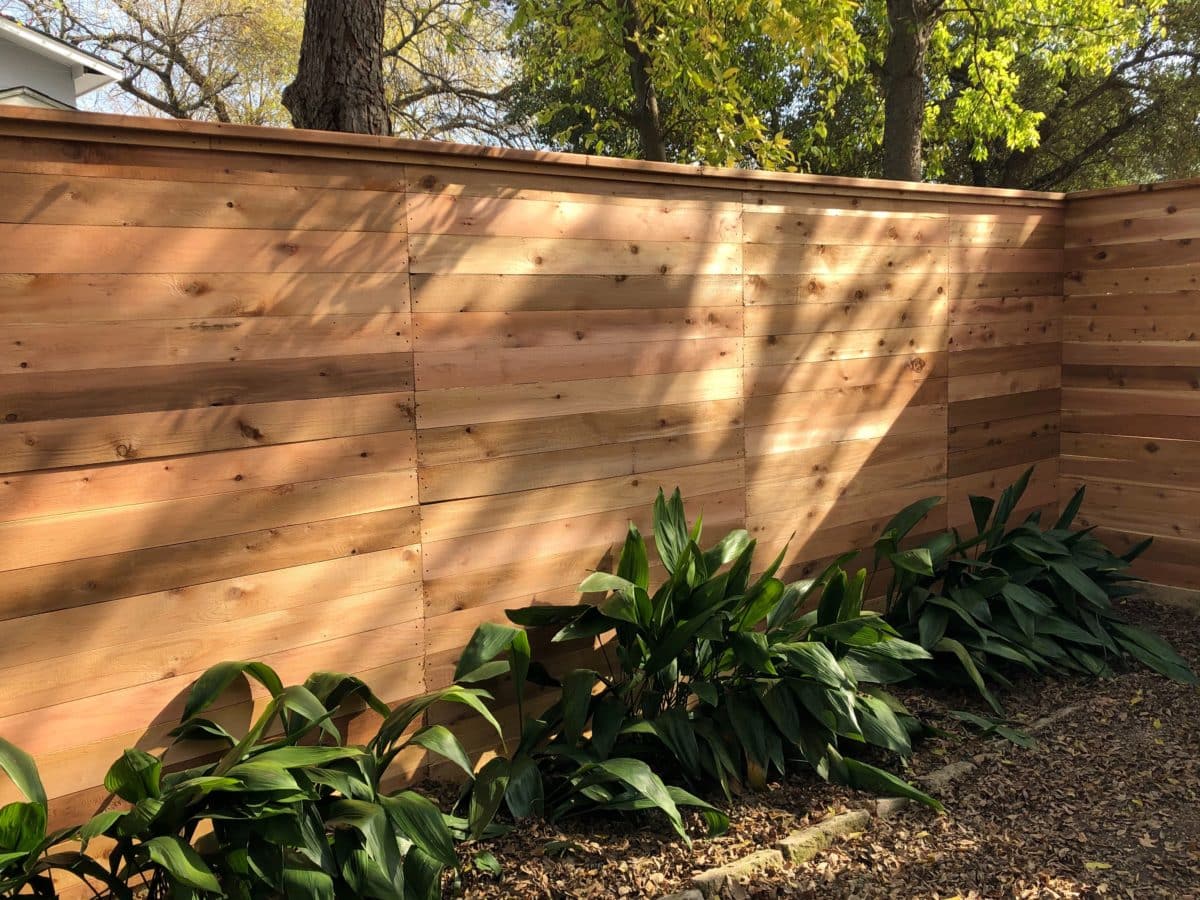 Horizontal wood fence with cap and trim