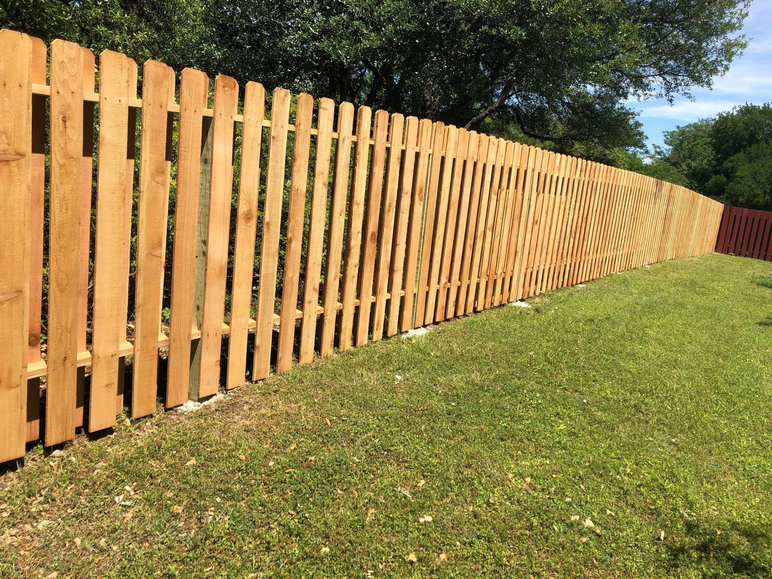 Shadowbox wood fence with pickets in an Austin backyard