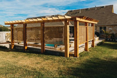 Pergola over a pool with lattice panels for privacy