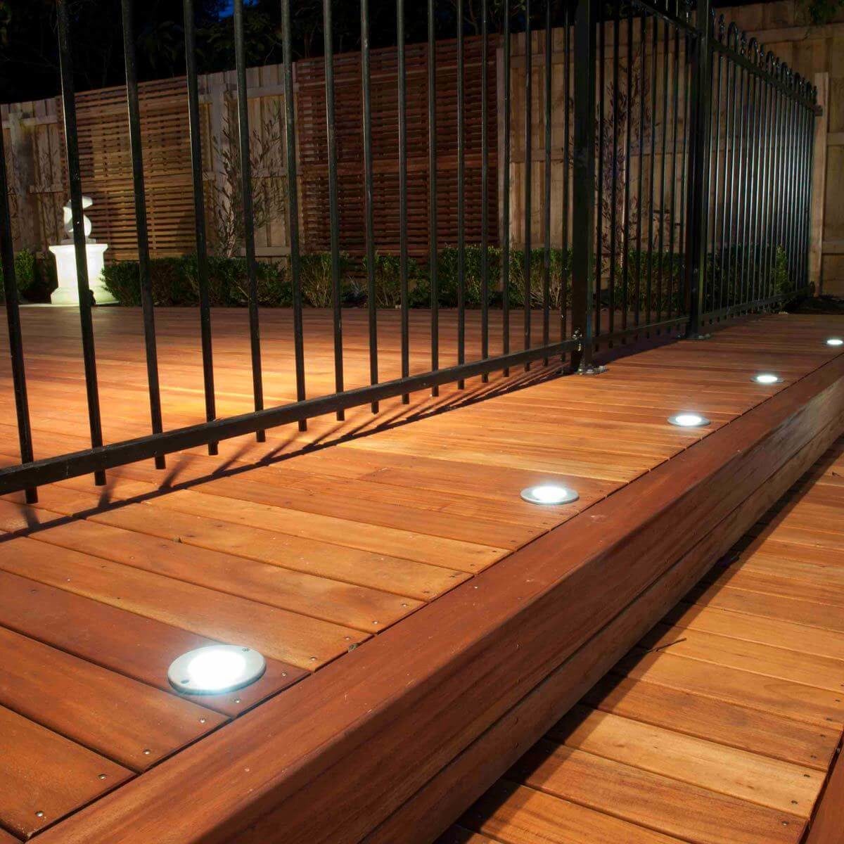 Wooden deck with iron railings and floor lights