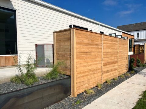 Horizontal wood fence with planter as a decorative fence idea