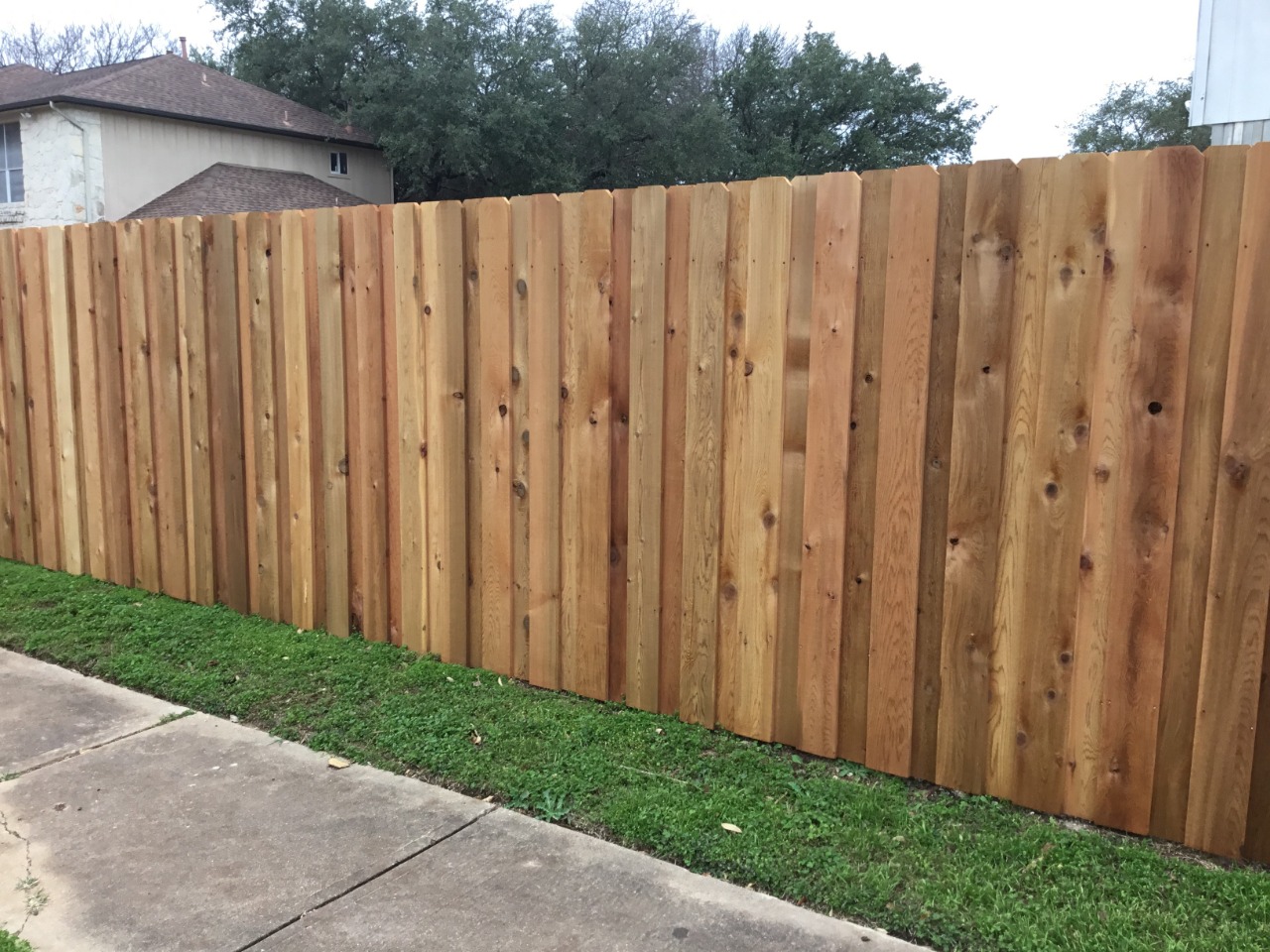 Six foot wooden board on board fence