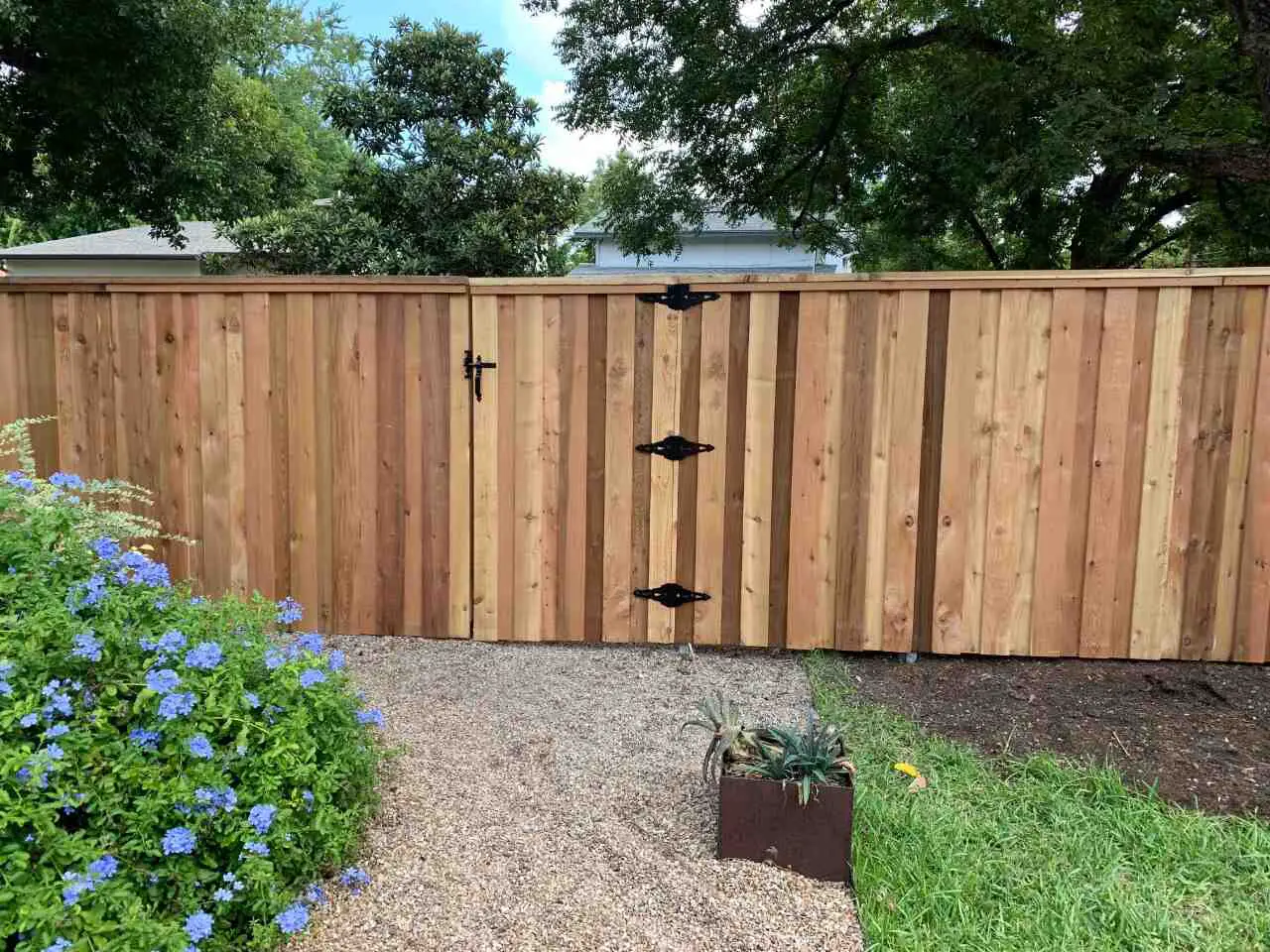 Six foot board on board fence with cap and trim using post masters