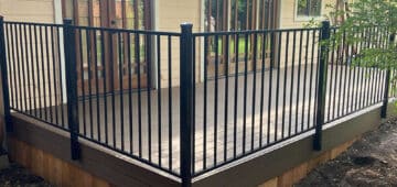 composite deck with iron railing and wood skirting