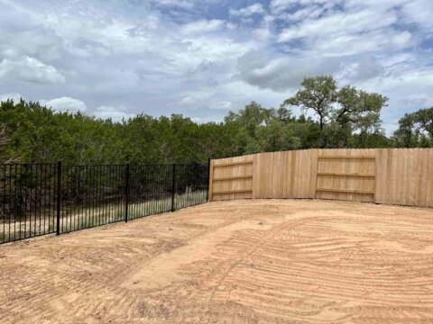 Iron fence with a Good Neighbor privacy fence