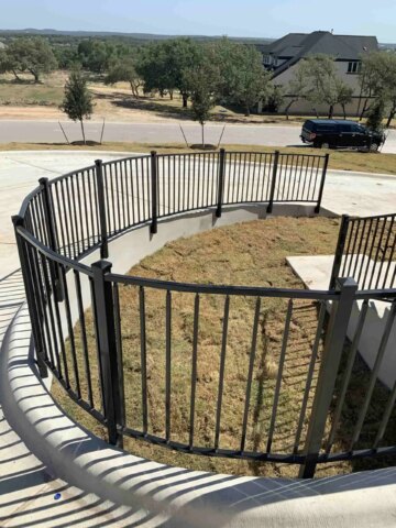 Curved iron fence along driveway