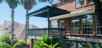Wooden pergola over two story deck with wooden railing