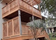 Two story deck with pergola covering top deck with cedar railings and lattice screen