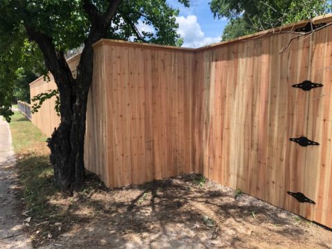 Eight foot privacy fence with cap and trim and 4 hinges on gate for durability