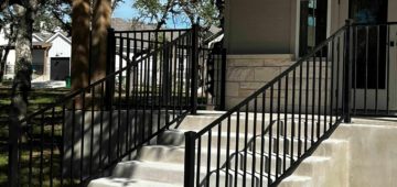 Black iron railing around front porch and down front steps