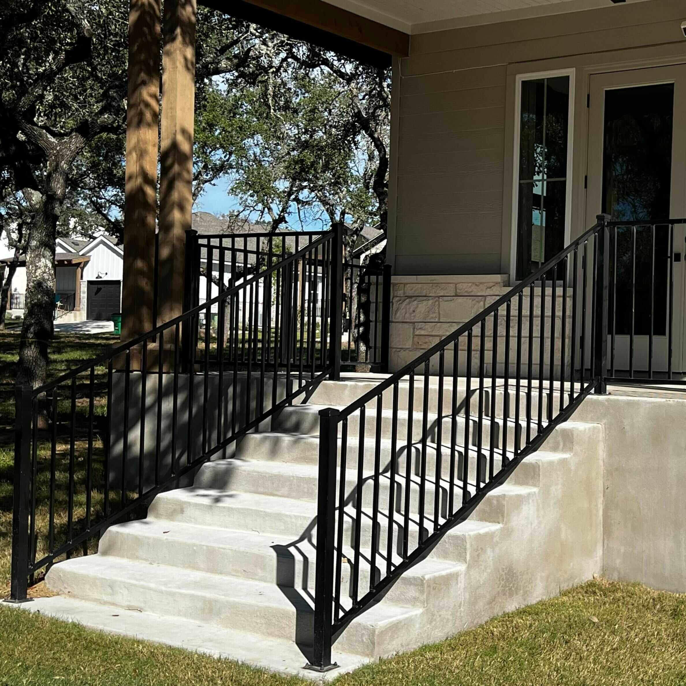 Black iron railing around front porch and down front steps
