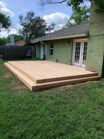 Low profile deck off back of house with no railing