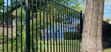 Residential flat top black iron fencing around front yard