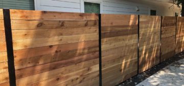 six foot horizontal cedar fence with black exposed posts