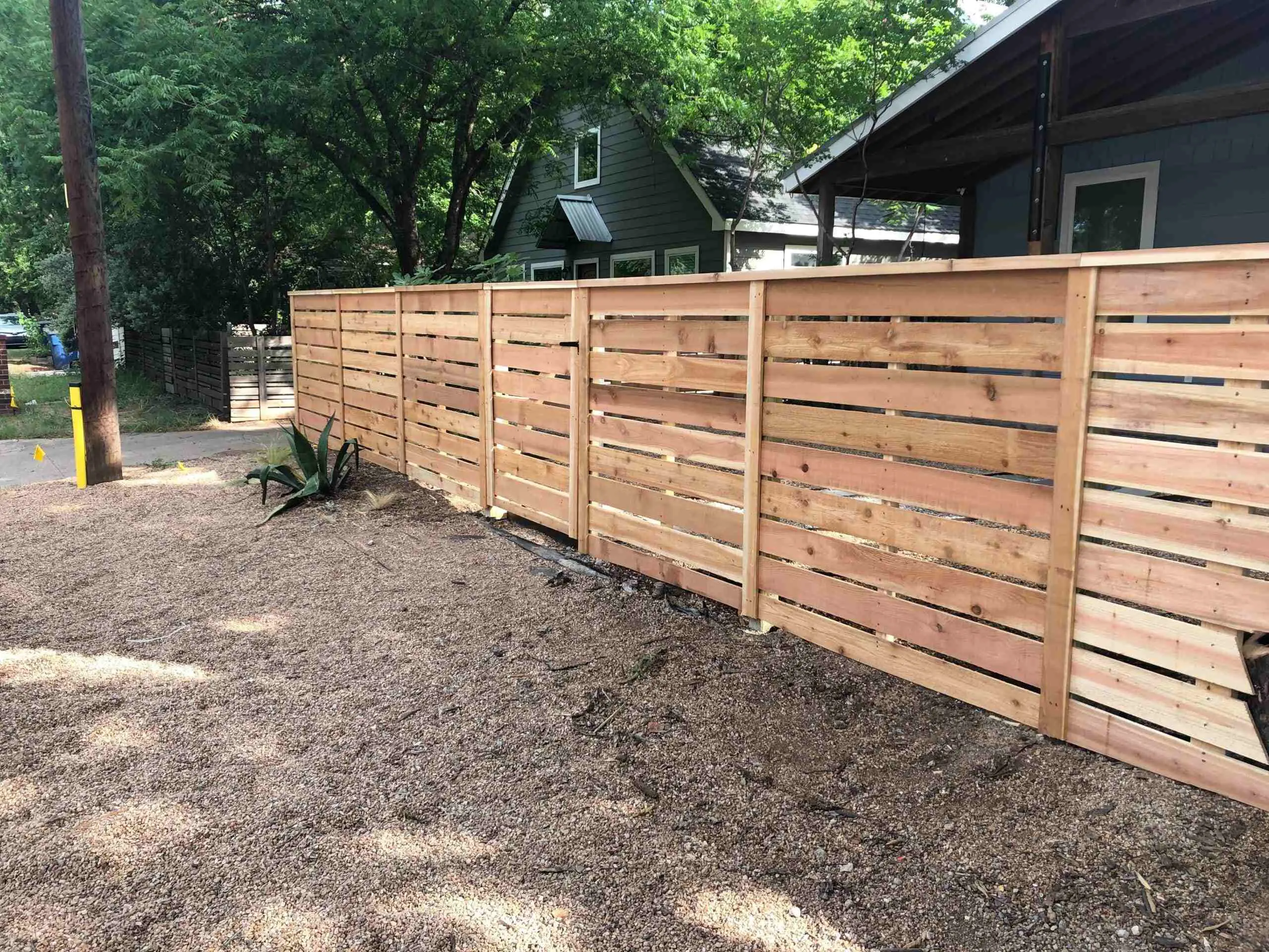 Six foot horizontal fence with one inch gaps between slats