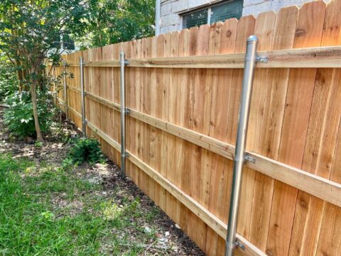 Six foot privacy fence with three rails and steel posts