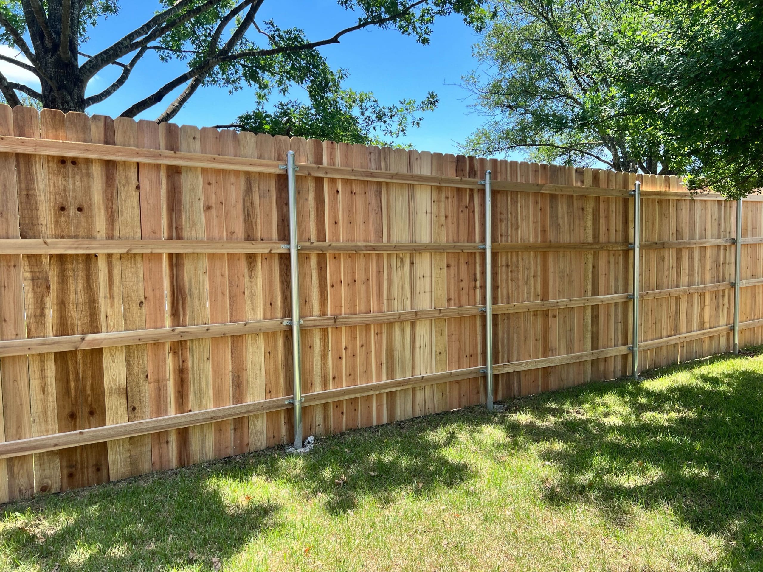 eight foot privacy fence with four rails and steel posts