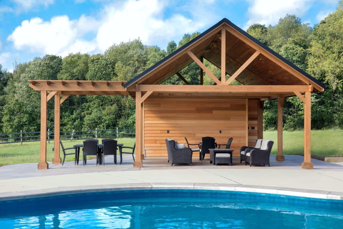 Triangle roof shape wood pergola attached to an open top wood pergola next to a pool