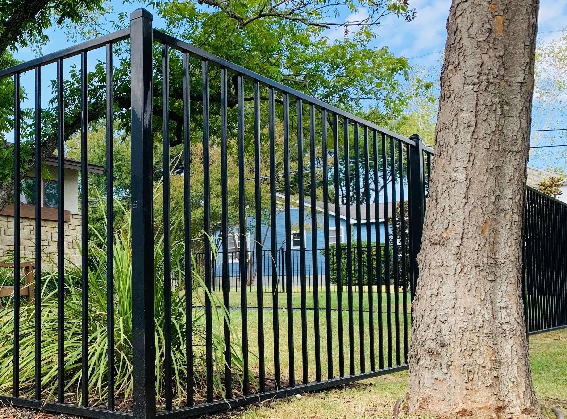 Iron fence with top cap in an Austin backyard