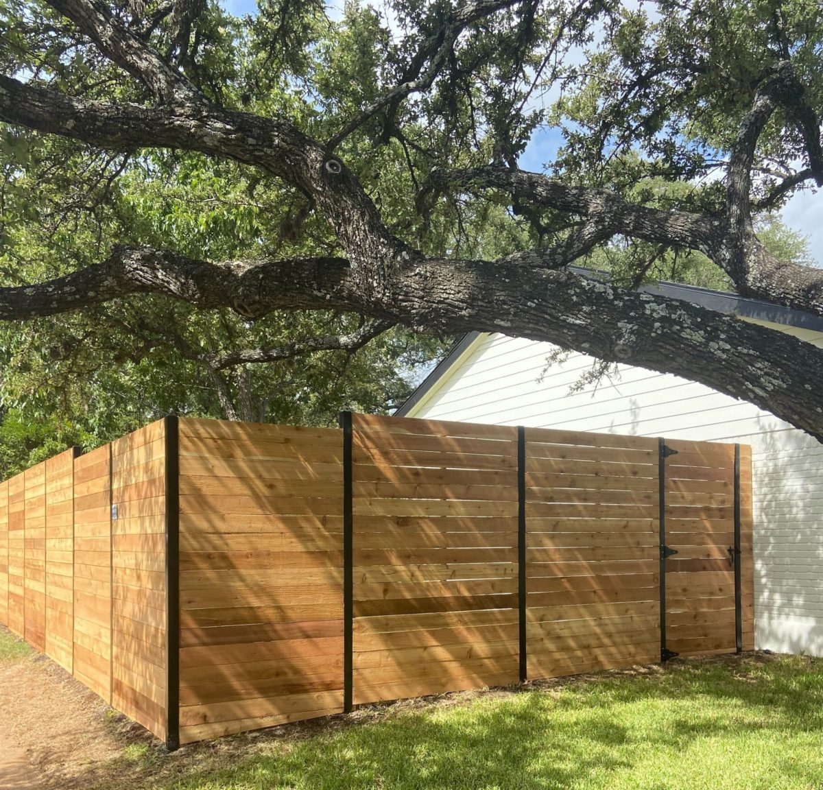 Horizontal cedar fence installation in an Austin backyard