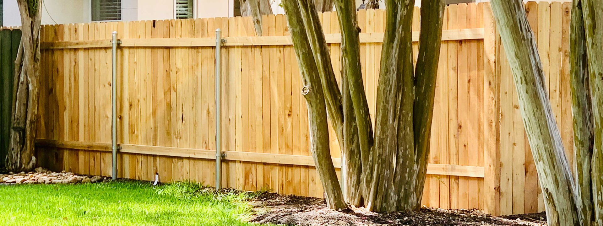 Wood fence with metal posts on the backyard of a property in Austin, Texas