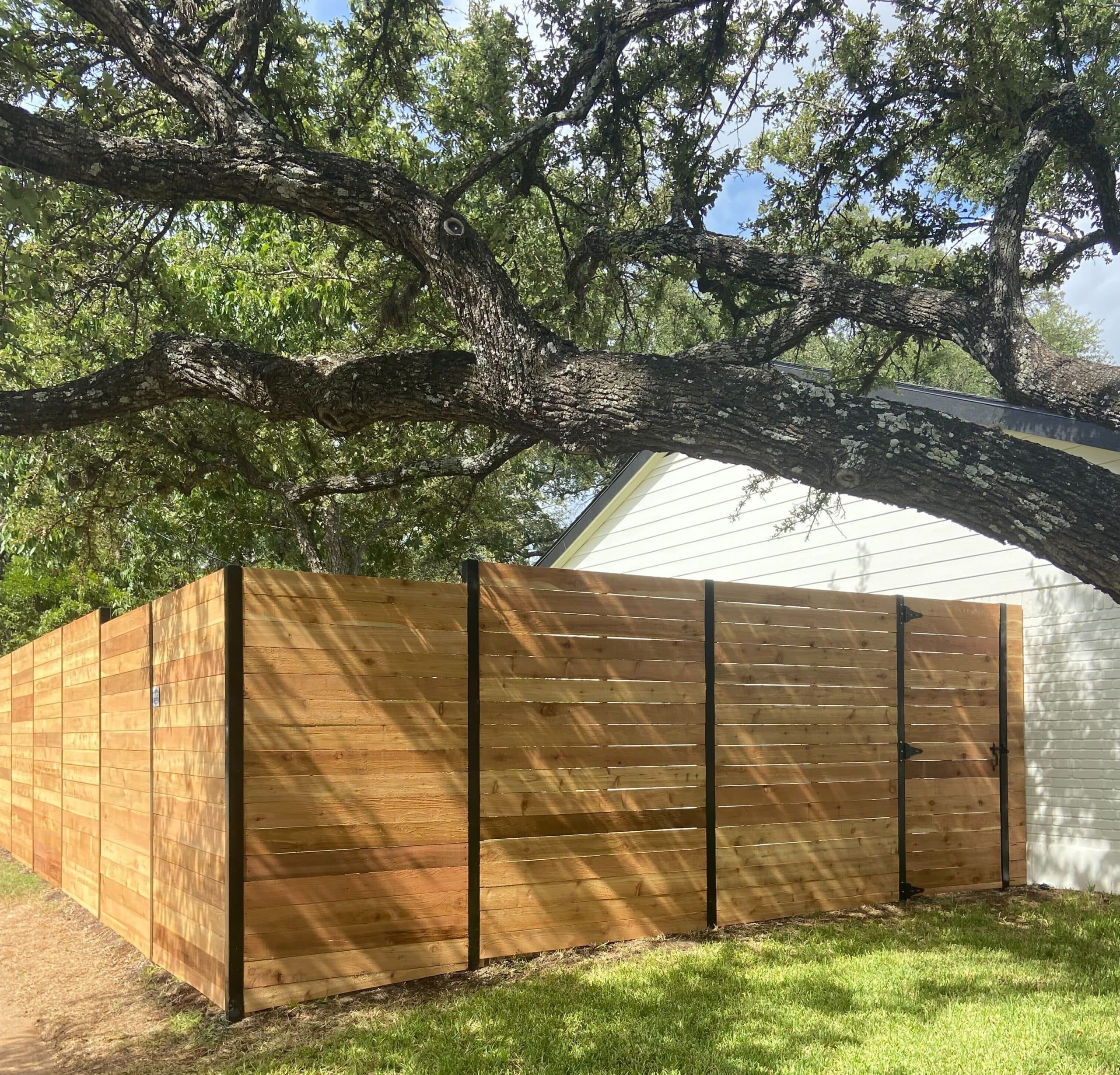 Horizontal wood fence with exposed black posts