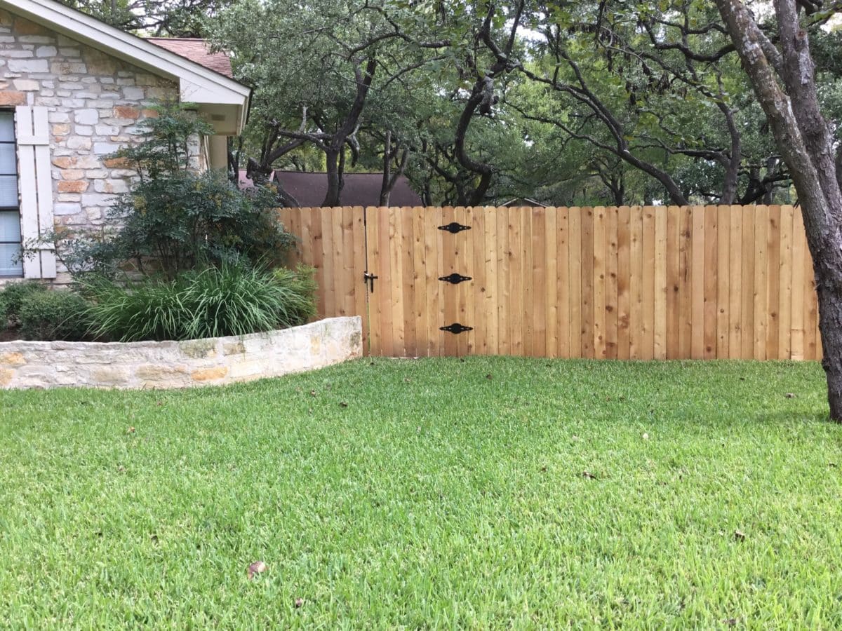 Privacy fence on the front of a house with fence gate to the backyard