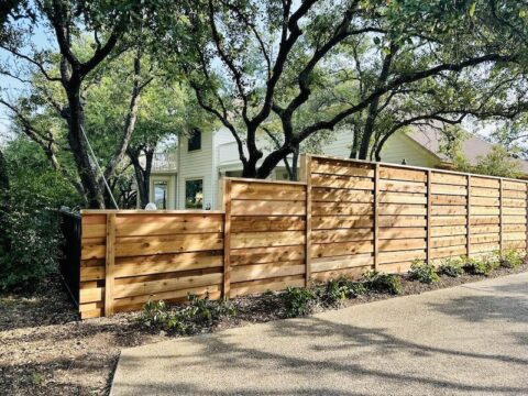 Horizontal wood board on board fence in an Austin property