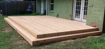 Low profile deck off back of house with no railing