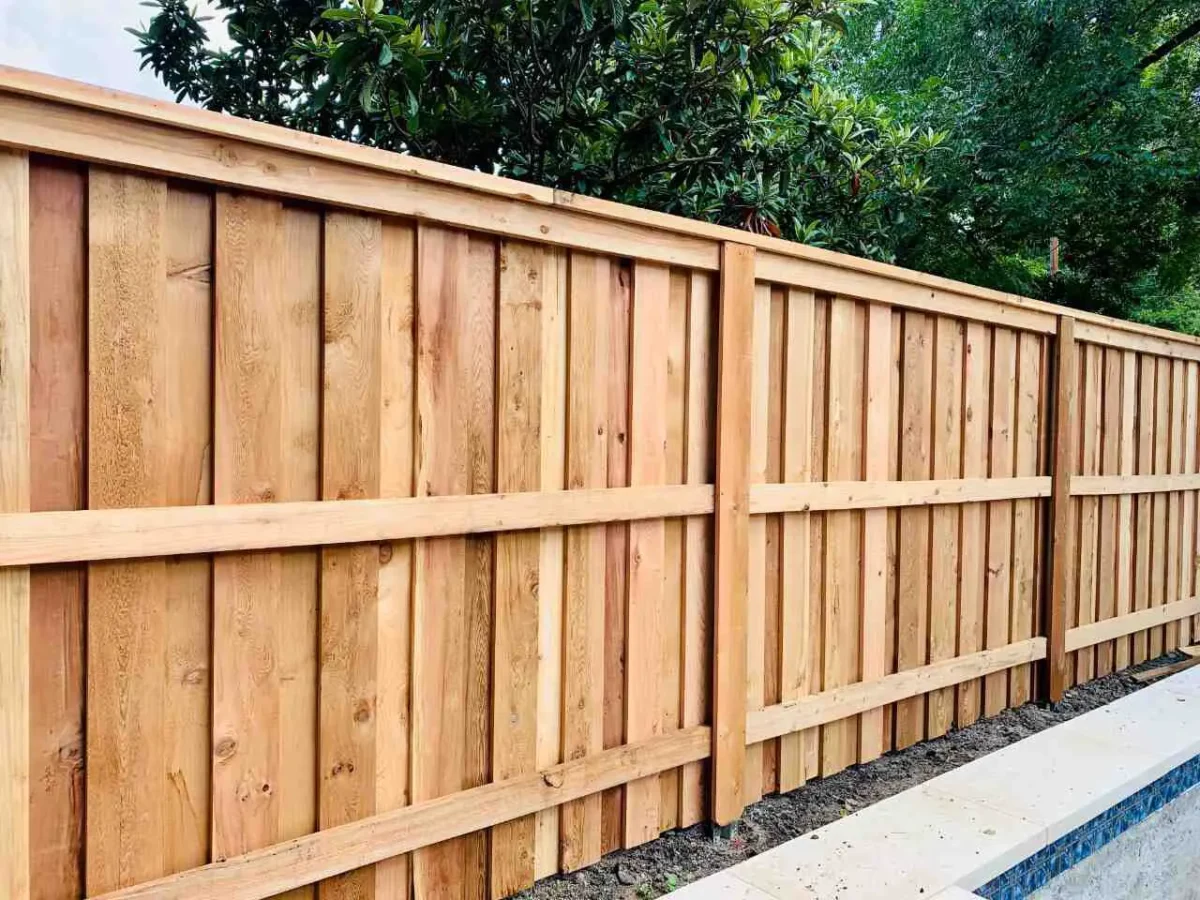 Board on board fence with post masters surrounding a pool in an Austin backyard